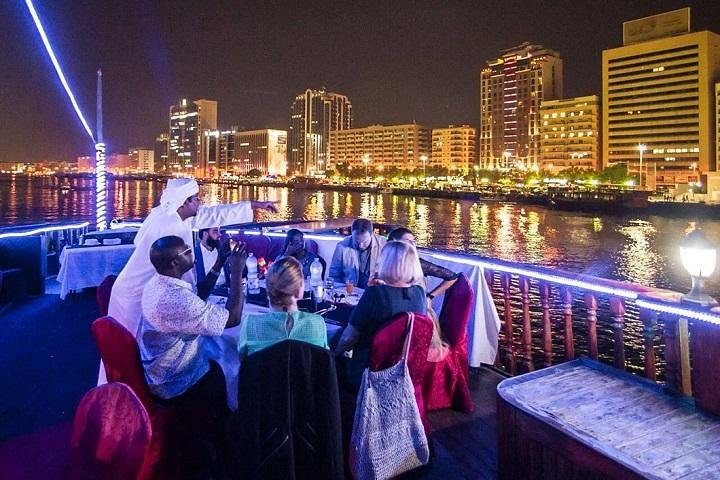 Experience the allure of Dubai's skyline while enjoying a serene dinner on a traditional dhow surrounded by shimmering waters and delightful company making memories that last a lifetime.